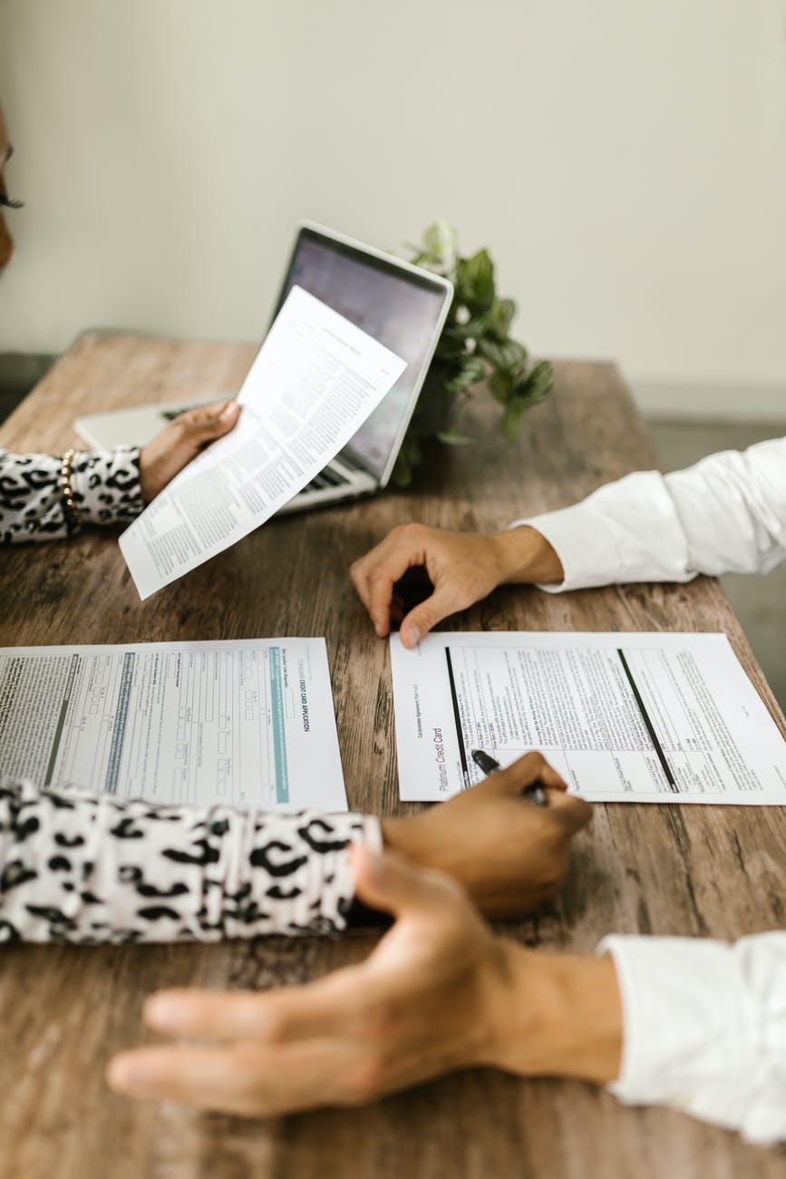 man and woman sitting at table with papers